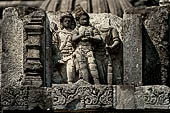 Prambanan - Candi Lara Jonggrang, miniature shrines surmounted by small fluted stupa with panels with musicians and dancers decorating the top of the balustrade 